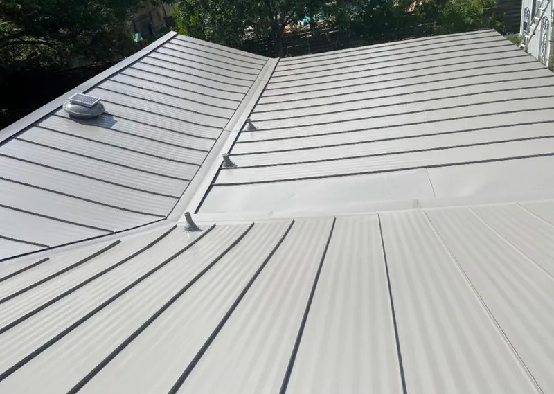 Solar attic fan installed on a metal roof for Roof Ventilation in Hugo